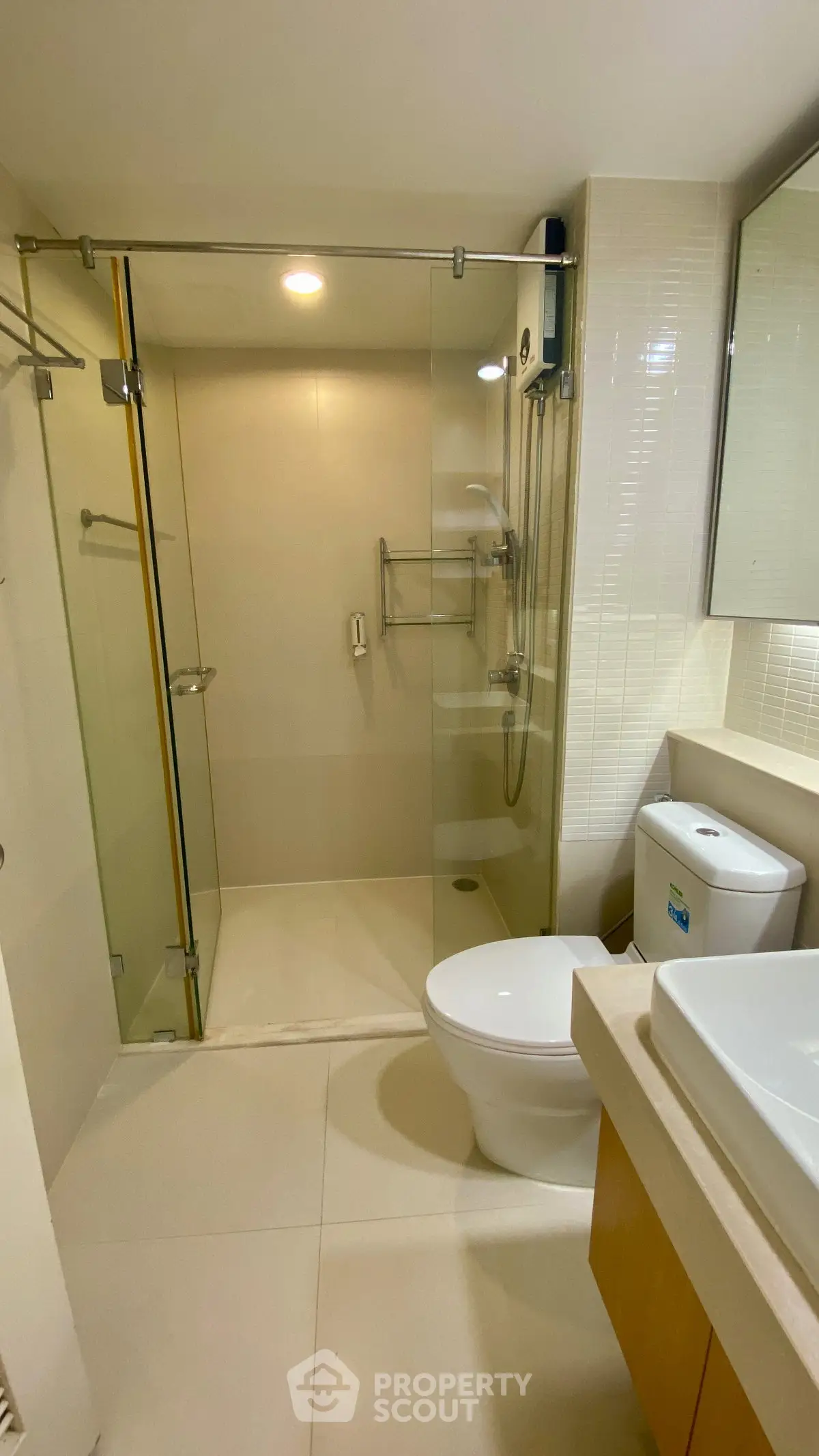 Modern bathroom with glass shower enclosure and sleek fixtures