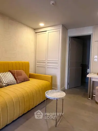 Modern living room with stylish yellow sofa and chic marble side table