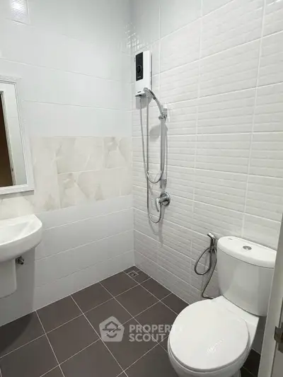 Modern bathroom with sleek white tiles and shower unit