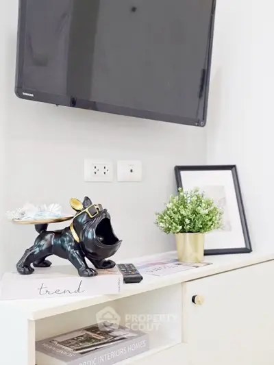 Stylish living room corner with TV, decor, and modern furniture