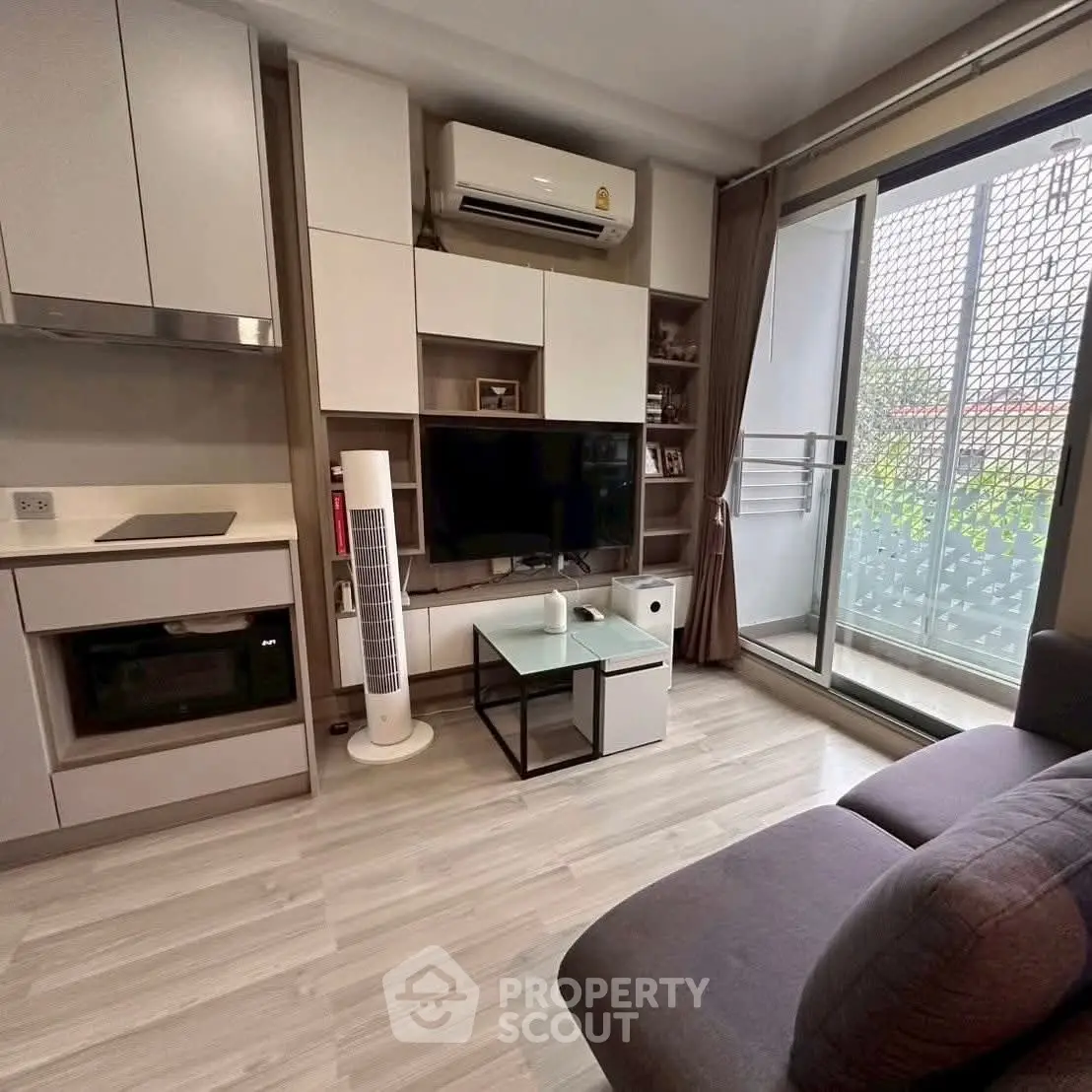 Modern living room with balcony access and sleek furniture design