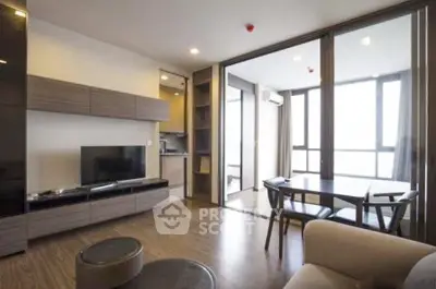 Modern living room with open layout and large windows offering natural light and city views.