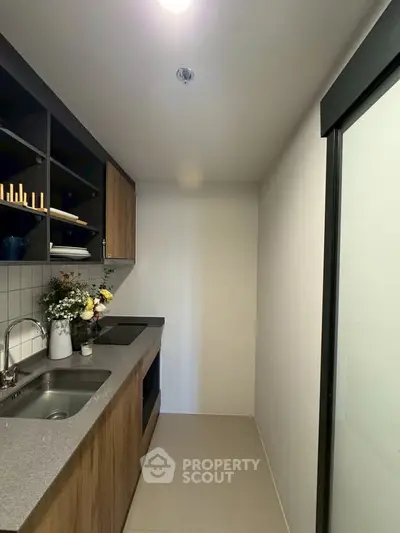 Modern compact kitchen with sleek cabinetry and stylish decor