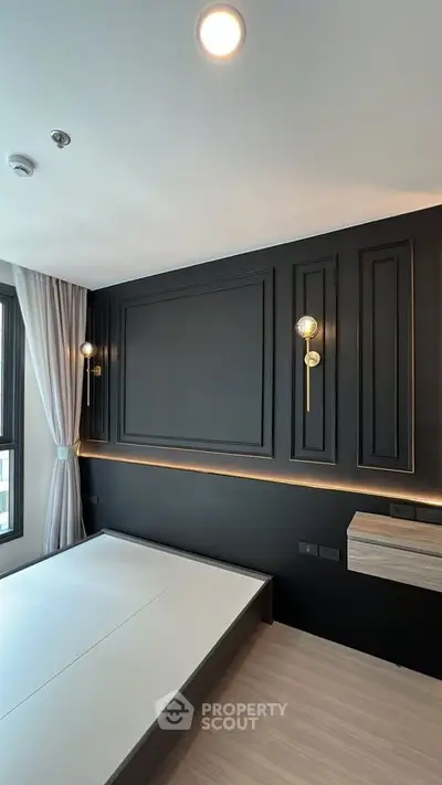Modern bedroom with sleek black accent wall and stylish lighting fixtures