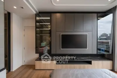 Modern bedroom with sleek TV unit and city view