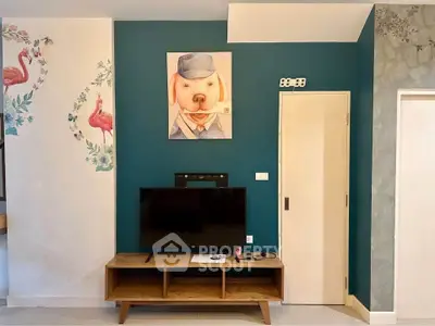 Stylish living room with unique wall art and modern TV setup.