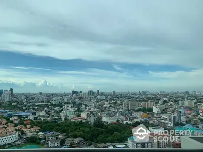 Stunning cityscape view from high-rise building showcasing urban skyline and lush greenery.