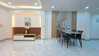 Modern dining area with elegant marble flooring and stylish wall decor