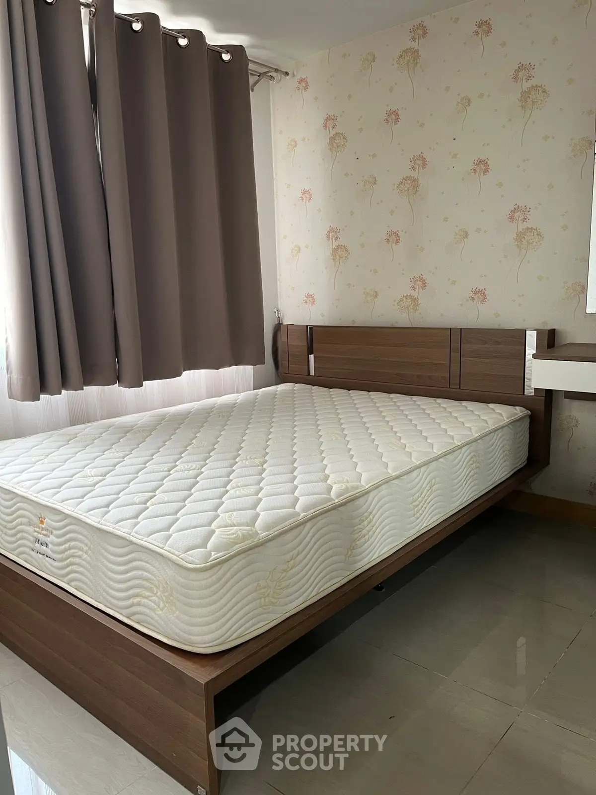 Cozy bedroom with stylish wallpaper and comfortable mattress in modern apartment.