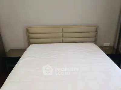 Modern bedroom with stylish headboard and side tables, perfect for a cozy retreat.