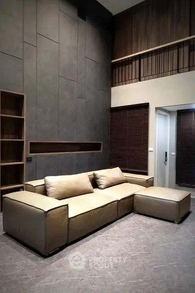 Modern living room with high ceiling and stylish beige sofa