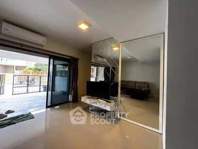 Spacious living room with modern decor and large sliding doors to patio