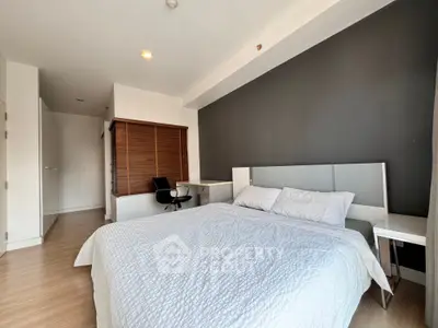 Spacious modern bedroom with stylish decor and natural light