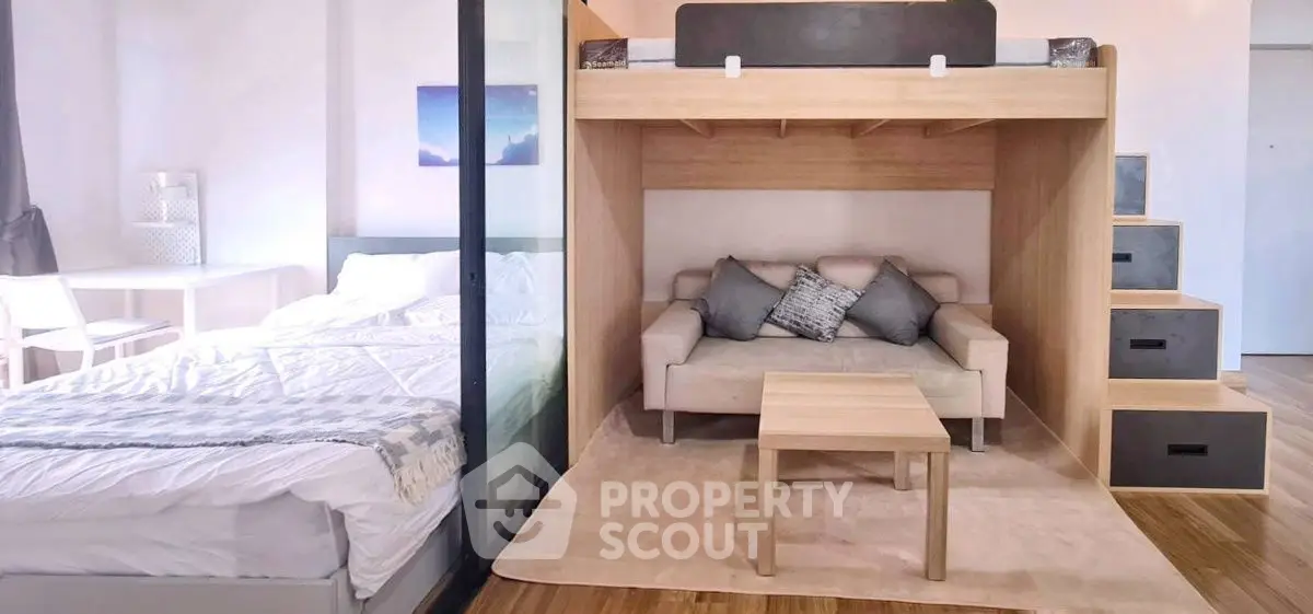 Modern studio apartment with loft bed and cozy living area