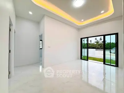 Spacious modern living room with elegant lighting and garden view