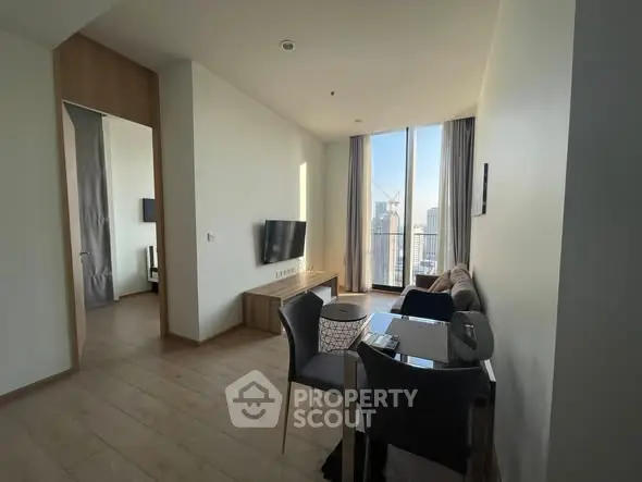 Modern living room with city view, sleek furniture, and natural light.
