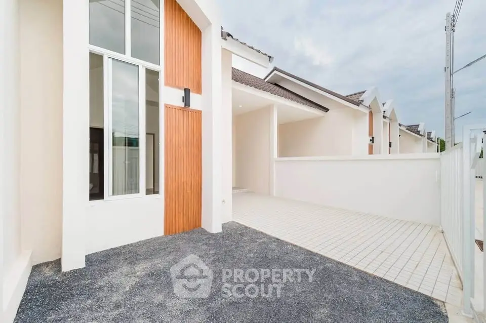 Modern townhouse exterior with sleek design and spacious driveway