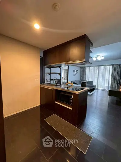 Modern open-layout kitchen with sleek appliances and spacious living area.