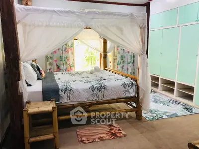 Charming bedroom with canopy bed and ample storage in a cozy setting.