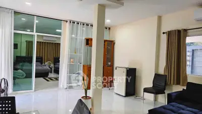 Spacious living room with modern decor and large windows for natural light.