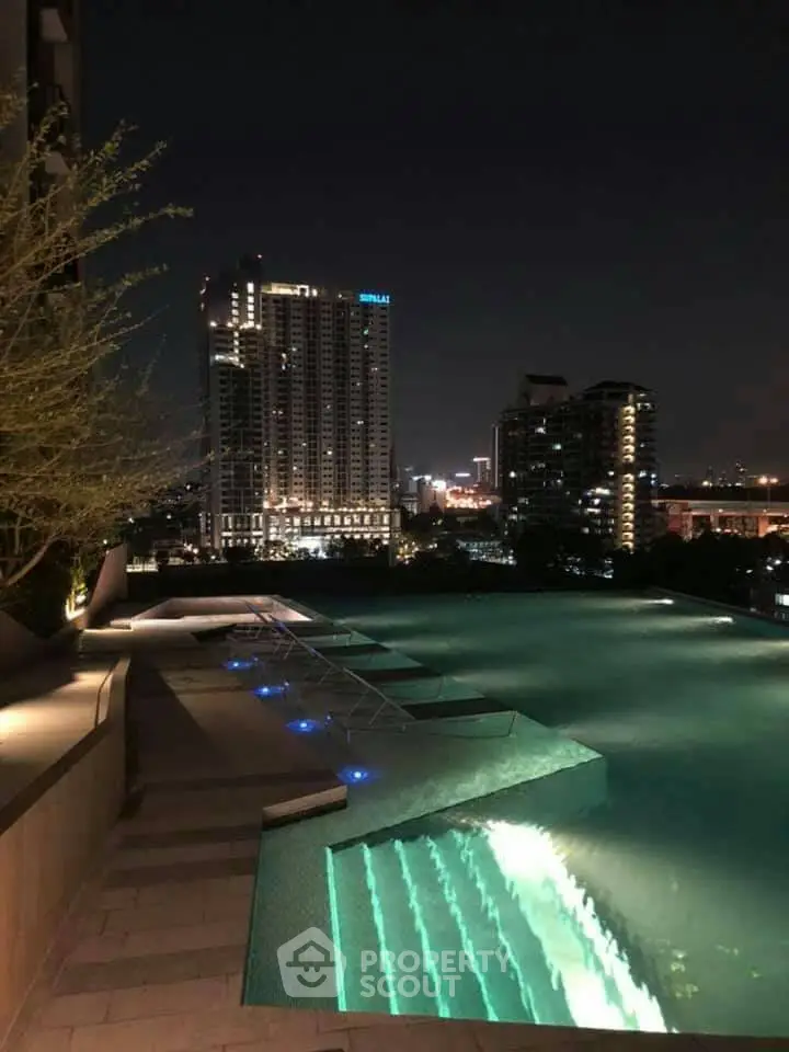 Luxurious rooftop pool with stunning city skyline view at night