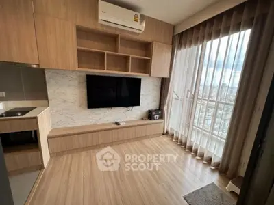 Modern living room with wooden flooring, built-in TV unit, and large window with city view.