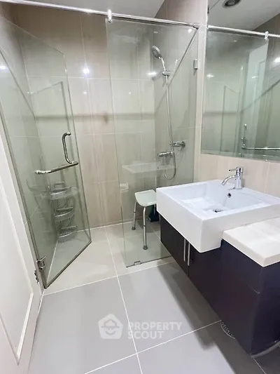 Modern bathroom with glass shower and sleek sink design