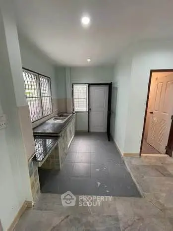 Spacious kitchen with closed layout and modern fixtures in a bright home.