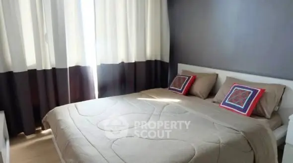 Cozy bedroom with modern decor and ample natural light