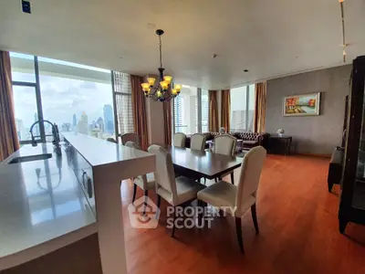 Luxurious open-plan living and dining area with panoramic city views and elegant furnishings.