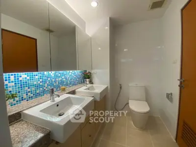 Modern bathroom with dual sinks and mosaic tile backsplash