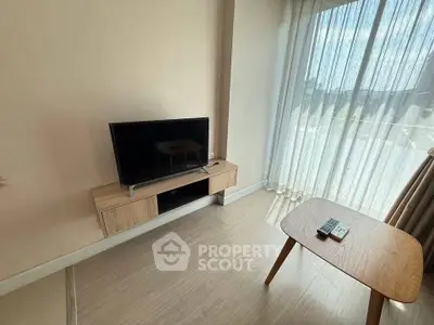 Modern living room with sleek TV setup and natural light