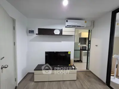 Modern living room with sleek TV unit and air conditioning in stylish apartment.