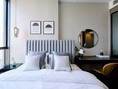 Luxurious modern bedroom with elegant decor and large windows offering natural light.