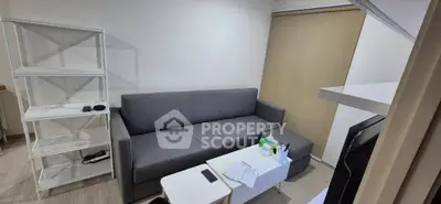 Modern living room with sleek gray sofa and minimalist decor