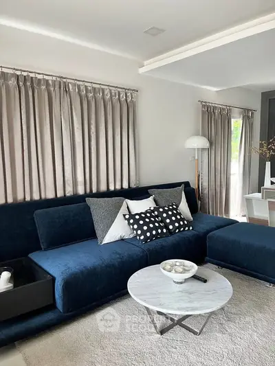 Elegant living room with plush blue sofa and modern decor