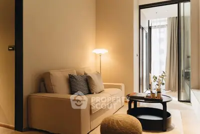Cozy living room with modern decor and natural light in a stylish apartment.