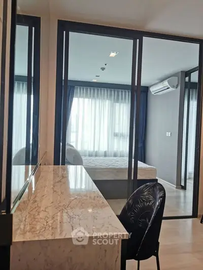 Modern bedroom with glass partition and elegant marble desk