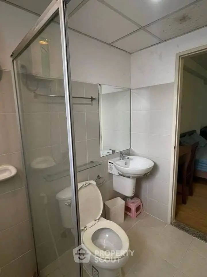 Compact bathroom with shower and toilet in modern apartment