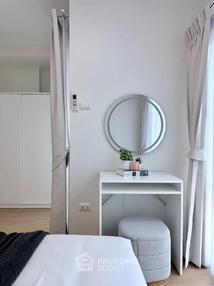 Chic bedroom with modern vanity and natural light, perfect for urban living.