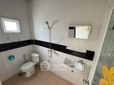 Modern bathroom with sleek fixtures and stylish black and white tile design.