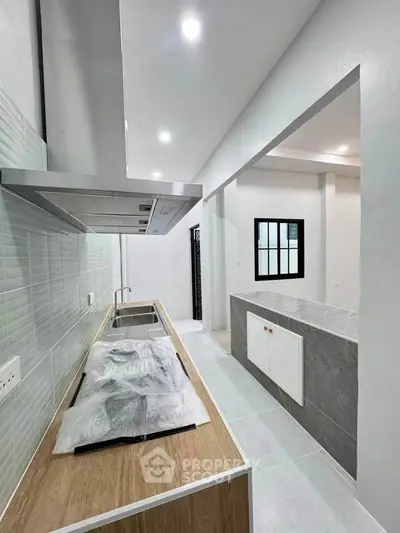 Modern kitchen with sleek design and open layout, featuring a stylish countertop and contemporary fixtures.