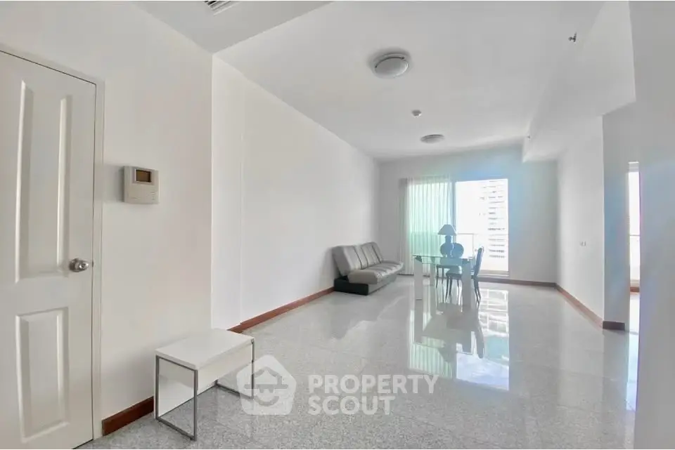 Spacious modern living room with sleek furniture and large windows