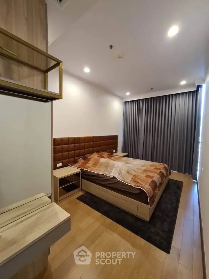 Modern bedroom with wooden flooring and stylish bed in a cozy apartment