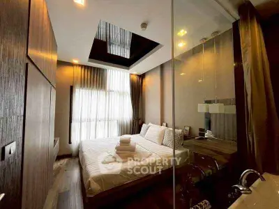 Luxurious modern bedroom with glass wall and elegant lighting