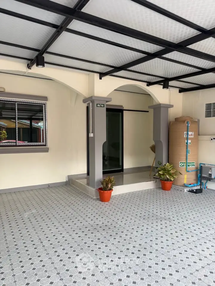 Spacious covered parking area with tiled flooring and modern design.