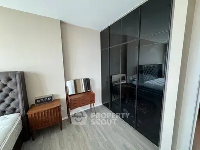 Modern bedroom with sleek black wardrobe and stylish furniture