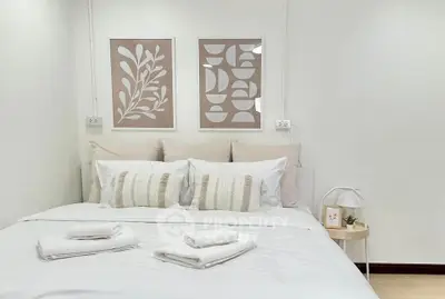 Cozy bedroom with stylish decor and soft lighting, perfect for relaxation.