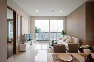 Modern living room with city view, elegant decor, and natural light.