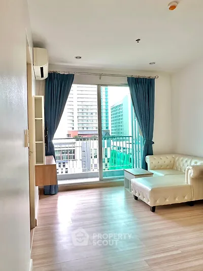 Bright living room with modern sofa and city view balcony.